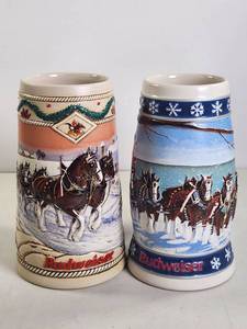lot 206 image: Budweiser Holiday Stein Pair with Horse-Drawn Sleigh and Lighthouse Designs