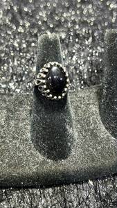 lot 18 image: Sterling silver Ring with Black Stone and Decorative Metal Setting