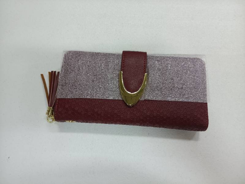 lot 8375 image: burgundy and glitter clutch wallet features a prominent gold-tone buckle closure and a matching side tassel.
