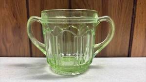 lot 105 image: Uranium Glass, Two-Handled Cup with Vertical Ribbed Pattern