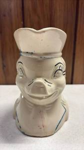 lot 162 image: Vintage cream-colored ceramic figural creamer pitcher depicting a pig dressed in a colonial hat with blue and red cold-paint accents, commonly attributed to mid-20th-century American potteries like McCoy or Shawnee.