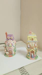 lot 226 image: Two Decorative Easter Bunny House Figurines with Egg Factory Detail -