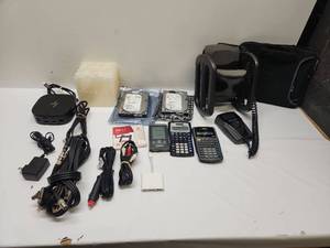 lot 28 image: Electronics Lot Hard Drives, Calculators, Headphones, Docking Station, Cables