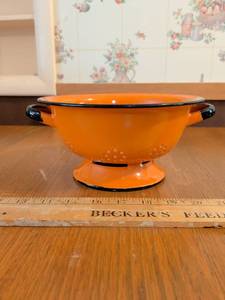 lot 556 image: Orange Enamel Colander with Black Trim and Handles