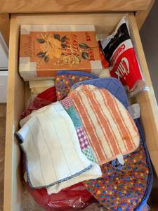 lot 613 image: Kitchen Drawer Lot Pot Holders, Trivets, Dish Cloths, Cheesecloth & Stationery Box