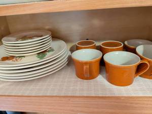 lot 616 image: Stoneware Dinnerware Set with Orange Mugs and Hand-Painted Floral Plates