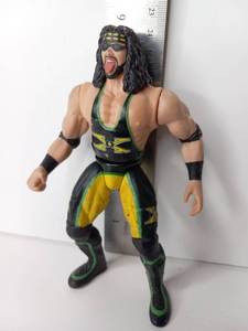 lot 33 image: Wrestling Action Figure with Black Hair Headband Yellow Green Outfit