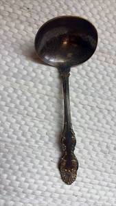 lot 1015 image: N.F. Silver Co. Silver plate Gravy Ladle with Ornate Handle