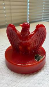 lot 1025 image: Fenton Red Slag Glass USA Bicentennial Eagle Paperweight , featuring a detailed bald eagle design on a round base.