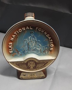 lot 3042 image: Vintage 19771978 Jim Beam Elks National Foundation 50 Years of Philanthropy commemorative porcelain whiskey decanter
