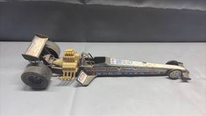 lot 2010 image: Vintage Processed Plastics NHRA X-Treme Machine rear-engine dragster toy car featuring a black plastic body and oversized rear slick tires