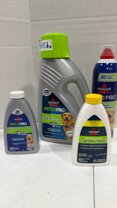 lot 1053 image: Bissell pet pro cleaning supplies (large one is less than half full)