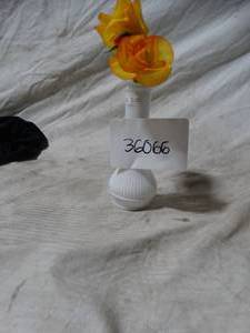 lot 36066 image: Small white vase with two synthetic roses and a small red flower