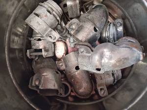 lot 36186 image: bucket filled with various components, threaded rigid metal conduit fittings, clamp style connectors and malleable iron junction box elbows