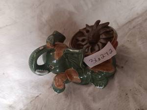 lot 36272 image: Green Elephant Decoration with bowl on its back, and a sun wall decoration