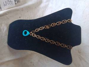 lot 38020 image: Golden colored Necklace with ovalcircular shapes, and a tealcyan Pendent
