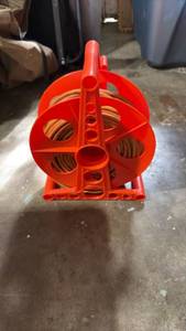 lot 52354 image: Red Cord Reel with Orange Extension Cord 100FT
