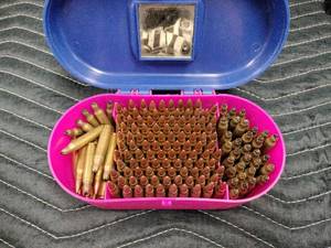 lot 13992 image: pink plastic case holding two types of rifle cartridges