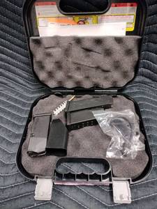 lot 27984 image: hard plastic factory case for a Glock semi-automatic pistol, Includes Accessories