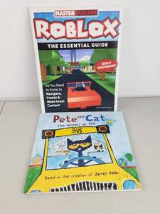 lot 235 image: 2 Books Roblox Master Builder The Essential Guide, Pete the Cat Wheels on the Bus