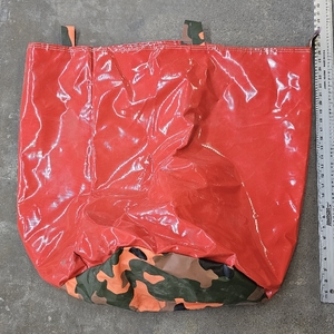 lot 3029 image: Vinyl storage bag red with camouflage bottom.
