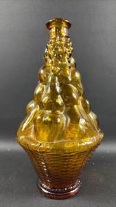 Vintage mid-century modern Empoli amber glass fruit basket genie bottle decanter featuring a textured basketweave base and fruit design