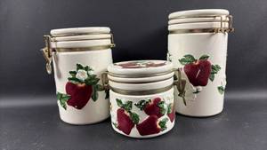 lot 225 image: Vintage KK ceramics apple canister set featuring embossed red apple and white blossom motif (Largest is Cracked But Cute)