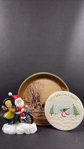 lot 238 image: Currier & Ives Round Tin, Santa & Mrs. Claus Figurine, and Snowman Wall Decor by Russ
