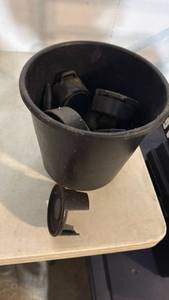 lot 5063 image: Black Round Container with Assorted Small Black Plastic Fittings Lot - Retail $0