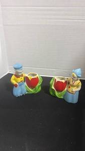 lot 1019 image: MCM ceramic Dutch boy and girl figural planters featuring hand-painted red tulip designs 5 inches tall
