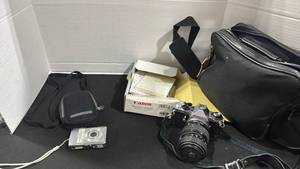 lot 1109 image: Pentax camera with bag and Cannon Digital camera with bag