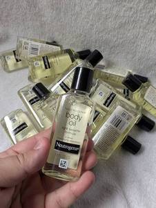 lot 1613 image: Neutrogena Body Oil Light Sesame Formula 1.25 fl oz Bottles Lot - 15 ct