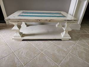 lot 30 image: Rustic, farmhouse-style wooden coffee table featuring a heavily distressed aesthetic.