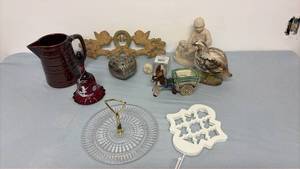 lot 319 image: Brown pitcher, Westmoreland bell, towel holder, donkey with cart, bird vase, jewelry box, cast iron coat hanger, cabinet pulls, boydog statue and clear glass candy dish.