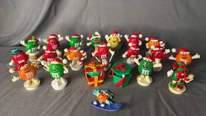 lot 400 image: 1997 M&Ms red candy character painting a toy train Christmas ornament and candy tube topper.