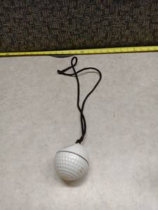 lot 1166 image: Closter Golf White Golf Ball w Black Cord Lanyard