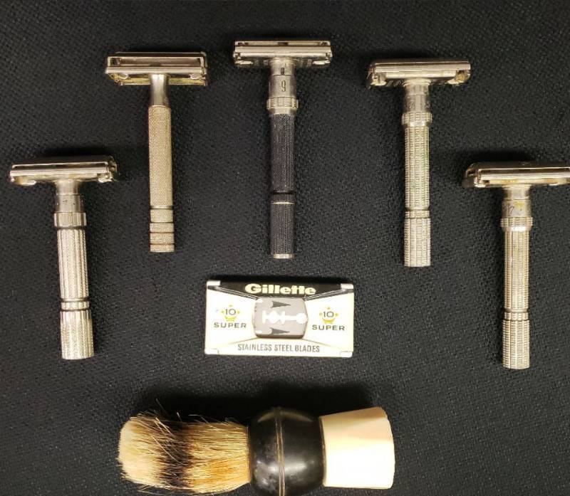 lot 123 image: Vintage Gillette Razors - 5 Stainless Steel - Stamped Gillette, Vintage Bakelite Shaving Brush, and Vintage Gillette Stainless Steel Blades in Original Pressed Tin Dispenser Case
