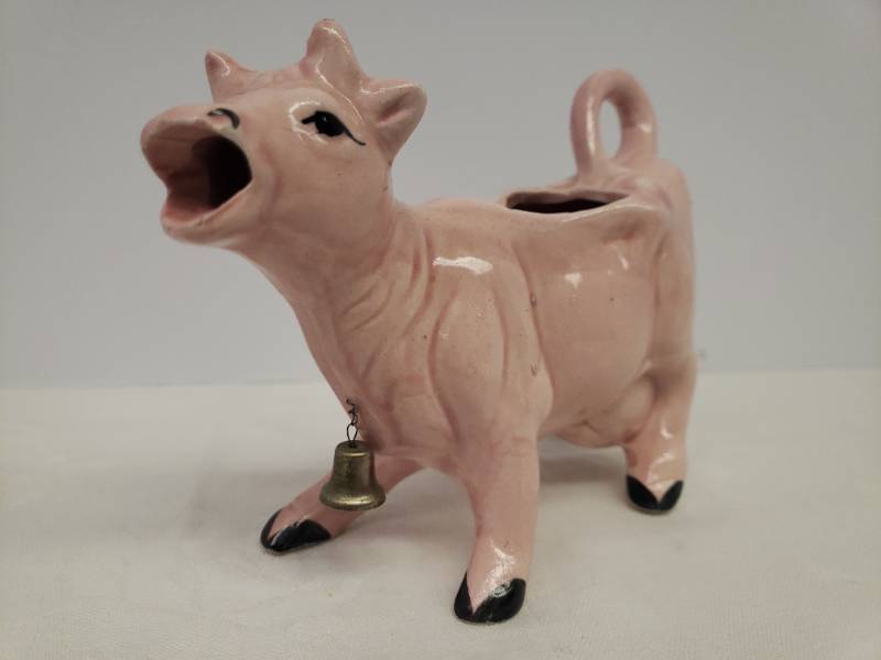 lot 129 image: Vintage 1950s Kenmar Kitchen Kitsch Pink Ceramic Jersey Cow Mouth Pour Creamer with Brass Bell - 5in T x 6.5in L