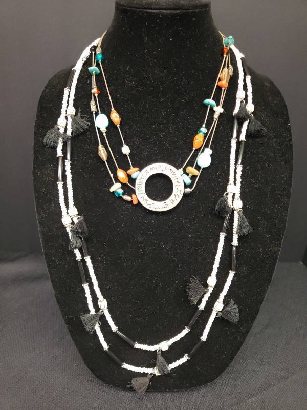 lot 142 image: 2 Vintage Chicos Tribal Style Necklaces - Black Tassel & Bone Color Beads 40in L, Multi-Color Stone with Hieroglyphic Medallion - 22in L