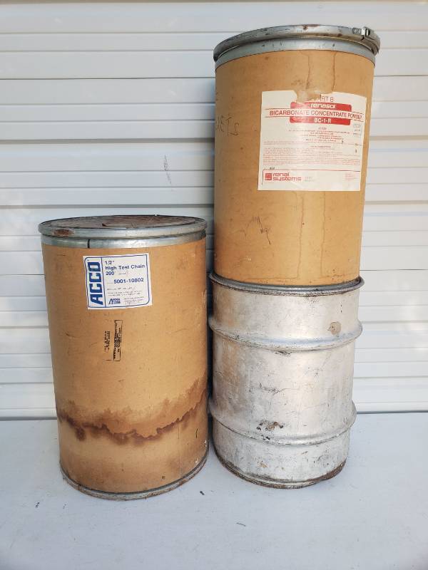 lot 148 image: Vintage Fiber Shipping DrumsHardboard Barrels - with Leverpack Lids - 16in W x 24in T and 18in W x 27in T, and One Steel BarrelDrum with Lid - 17in W x 21in T