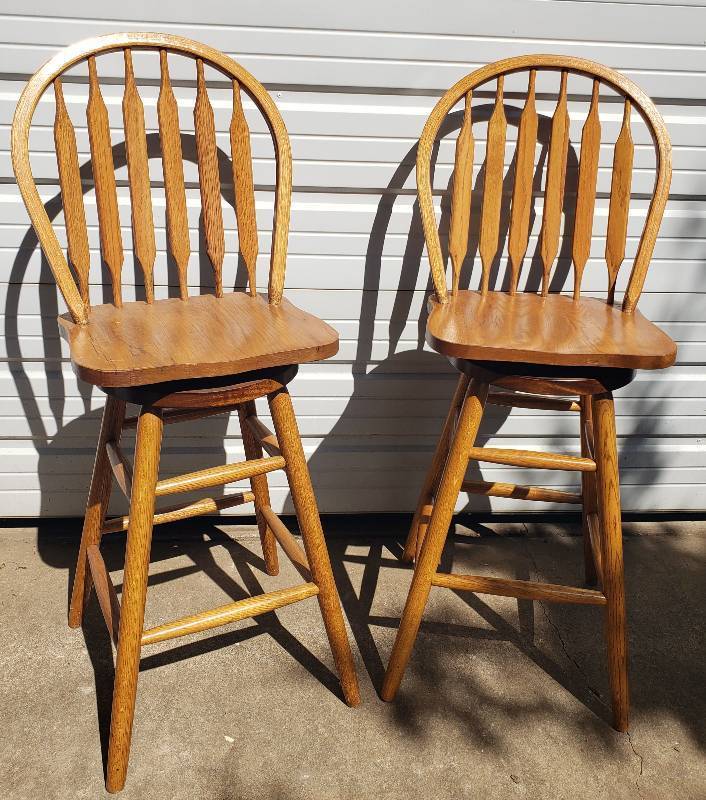 lot 4 image: Pair of Solid Oak Swivel Bar Stools - Curve Top Slat Backs - with Base Foot Rails - Seat Height 30in T - Back Height 47in T