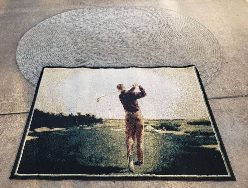 lot 182 image: Oval Rolled Coil Fabric Rug - 82in L x 62in W, and Shaw Rugs Golfer Design Area Rug - 39in x 56in