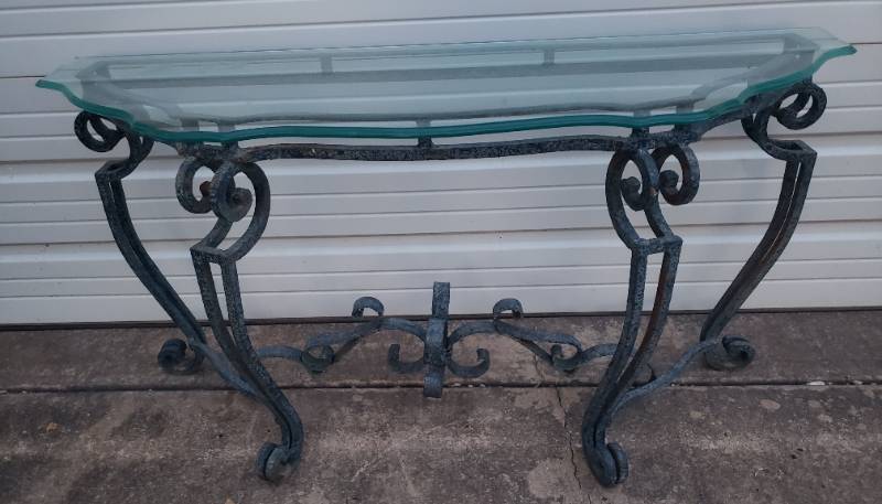 lot 53 image: Vintage Cast Iron Scroll Design Base EntryConsole Table with Beveled Gass Top - one chip on back left corner - 53in W x 18in D x 27in T