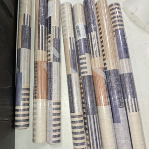 lot 78254 image: 8 Rolls of Peel and stick wallpaper geometric stripe pattern in shades of blue, beige, and cream. 17.3x113