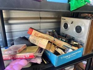 lot 53 image: Shelf full of items such as Shotgun Cleaning Kit with Plastic Case and Contents, old recorder, wall decor, vintage boxes