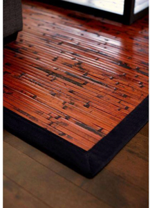 rolled-up mahogany bamboo area rug with a black cotton border - Retail: $0