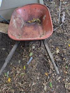 lot 977 image: Red Single-Wheel Wheelbarrow with Wood Handles