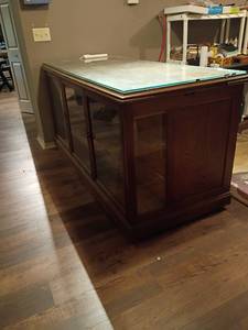 lot 900 image: Wooden Display Cabinet with Glass Shelves, Doors and Glass Top.   Has 18 drawers.  Also comes with extra drawer pulls.    36 x 73 x 31. You will need to bring help to remove