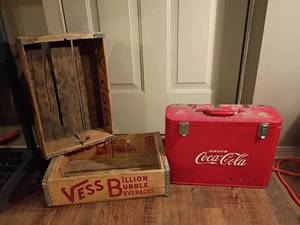 lot 904 image: Vintage Metal, Red Coca Cola Cooler.  12 x 17 x 7.  Comes with 2 Wooden Vess Soda Boxes.  Hinges on cooler need repair and old tape needs removed.  The outside has some rust and a hole, but it doesnt go all the way thru