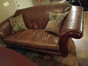 lot 910 image: Leather Couch with Throw Pillows.   Needs cleaned 36 x 94 x 38 in